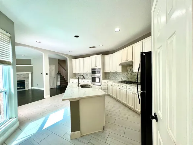 a large kitchen with a large window