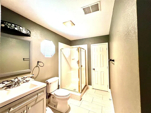 a bathroom with a sink mirror toilet and shower