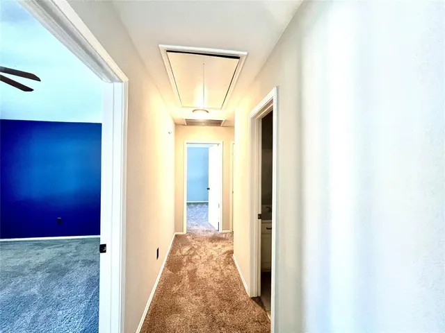 a view of a room with wooden floor and windows