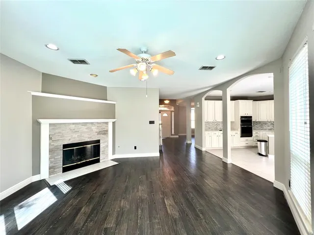 a view of an empty room with a fireplace and a window