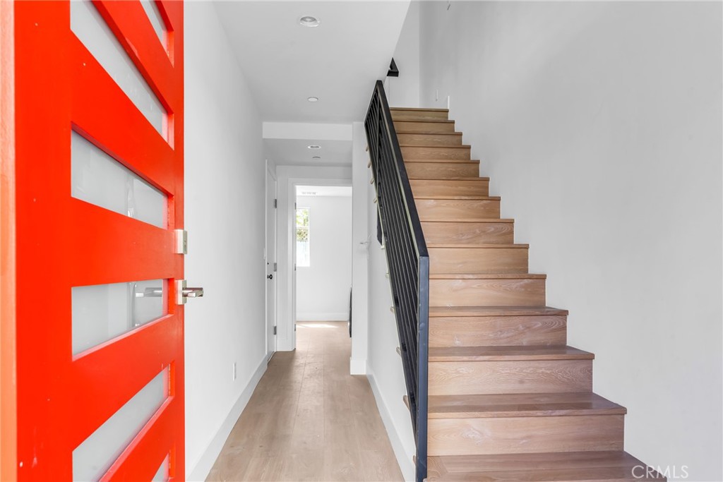 4453 Colfax Avenue, Unit 1 Studio City, CA 91602 - Photo 11 of 71 a view of staircase with wooden floor and lots of frames on wall