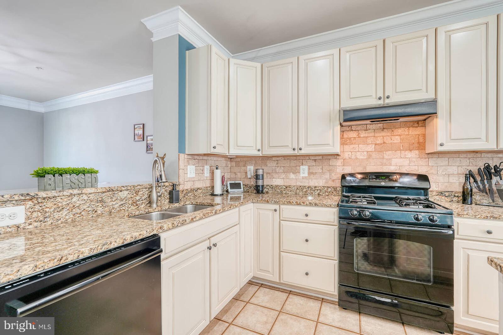 5183 Wyndholme Circle Baltimore, MD 21229 - Photo 11 of 31 a kitchen with granite countertop a sink stove and cabinets