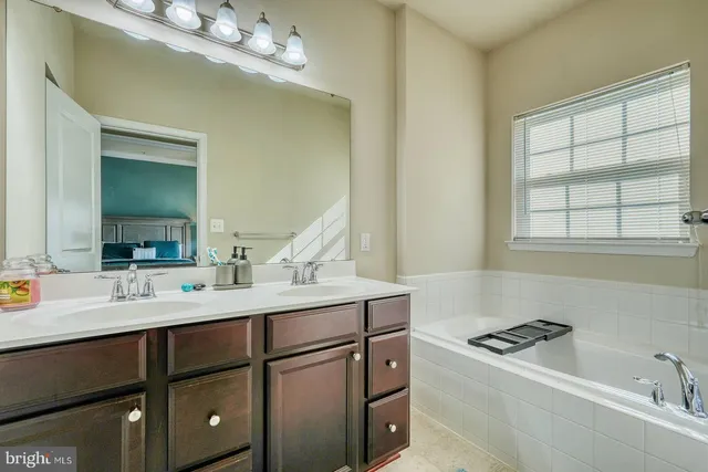 a bathroom with a sink double vanity and a mirror