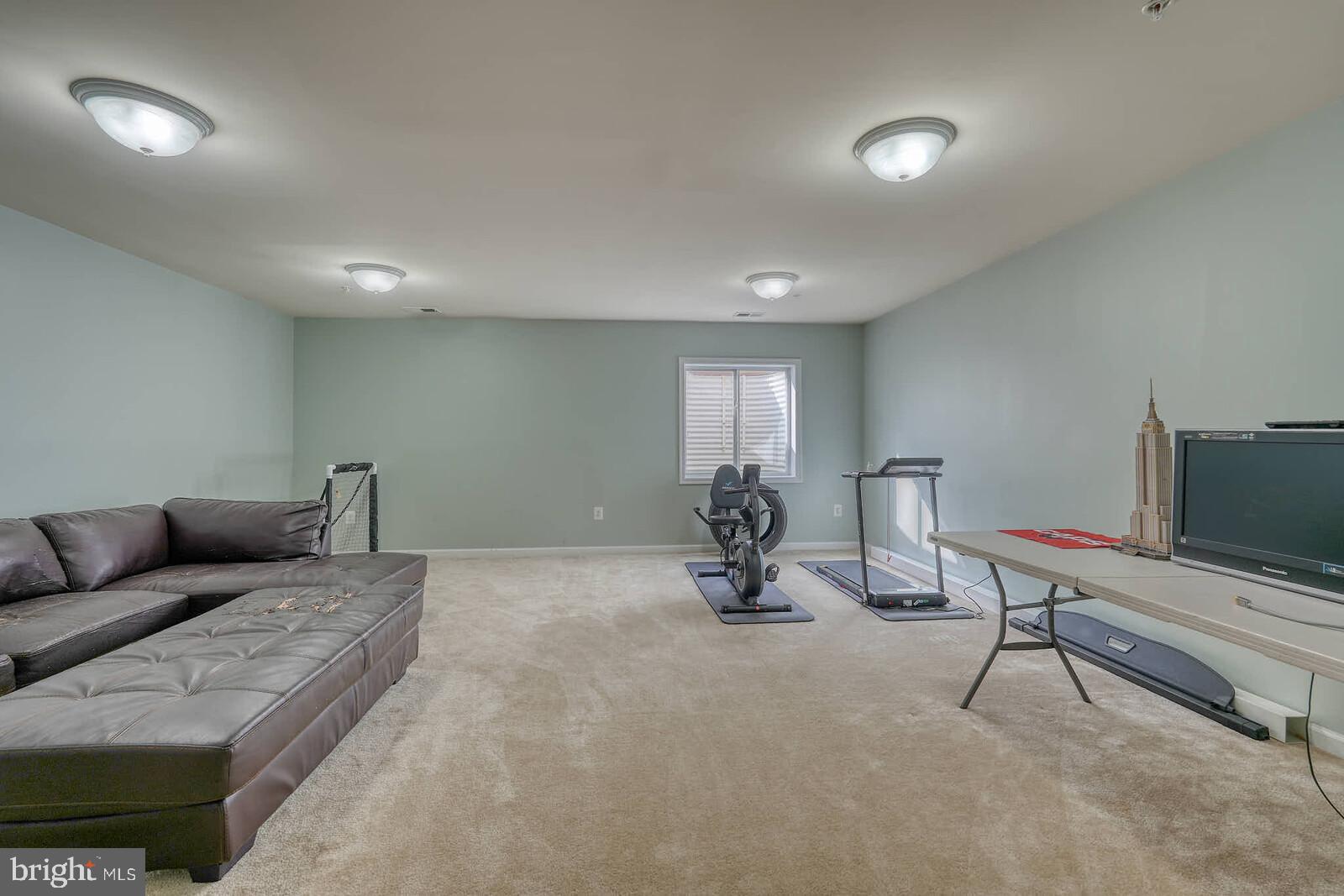 5183 Wyndholme Circle Baltimore, MD 21229 - Photo 23 of 31 a living room with furniture and a flat screen tv