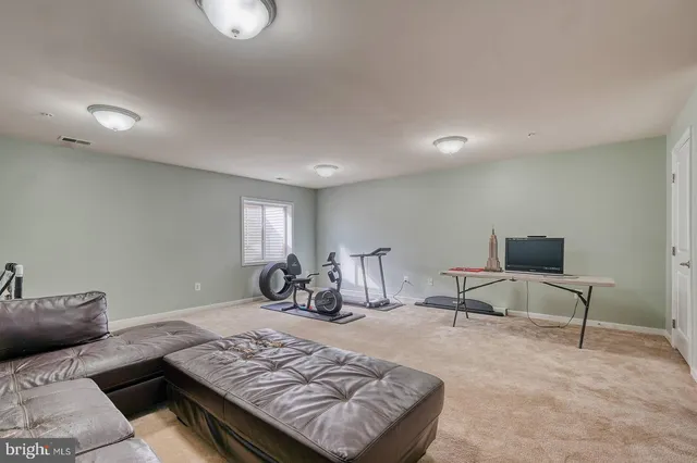 a living room with furniture and a rug