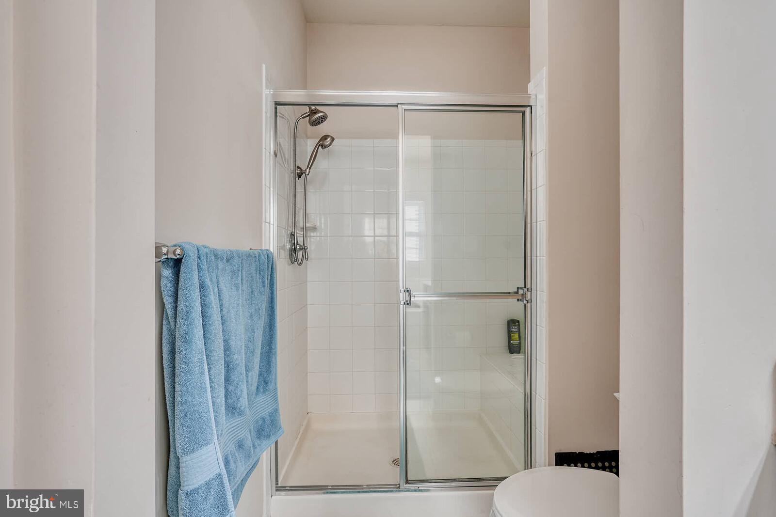 5183 Wyndholme Circle Baltimore, MD 21229 - Photo 26 of 31 a bathroom with a glass shower door