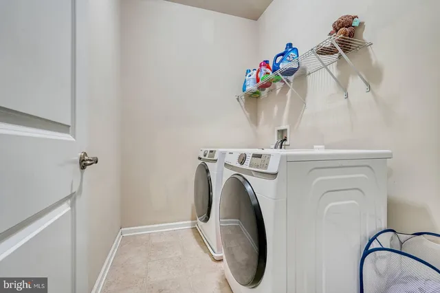 a close view of a utility room with dryer and washer