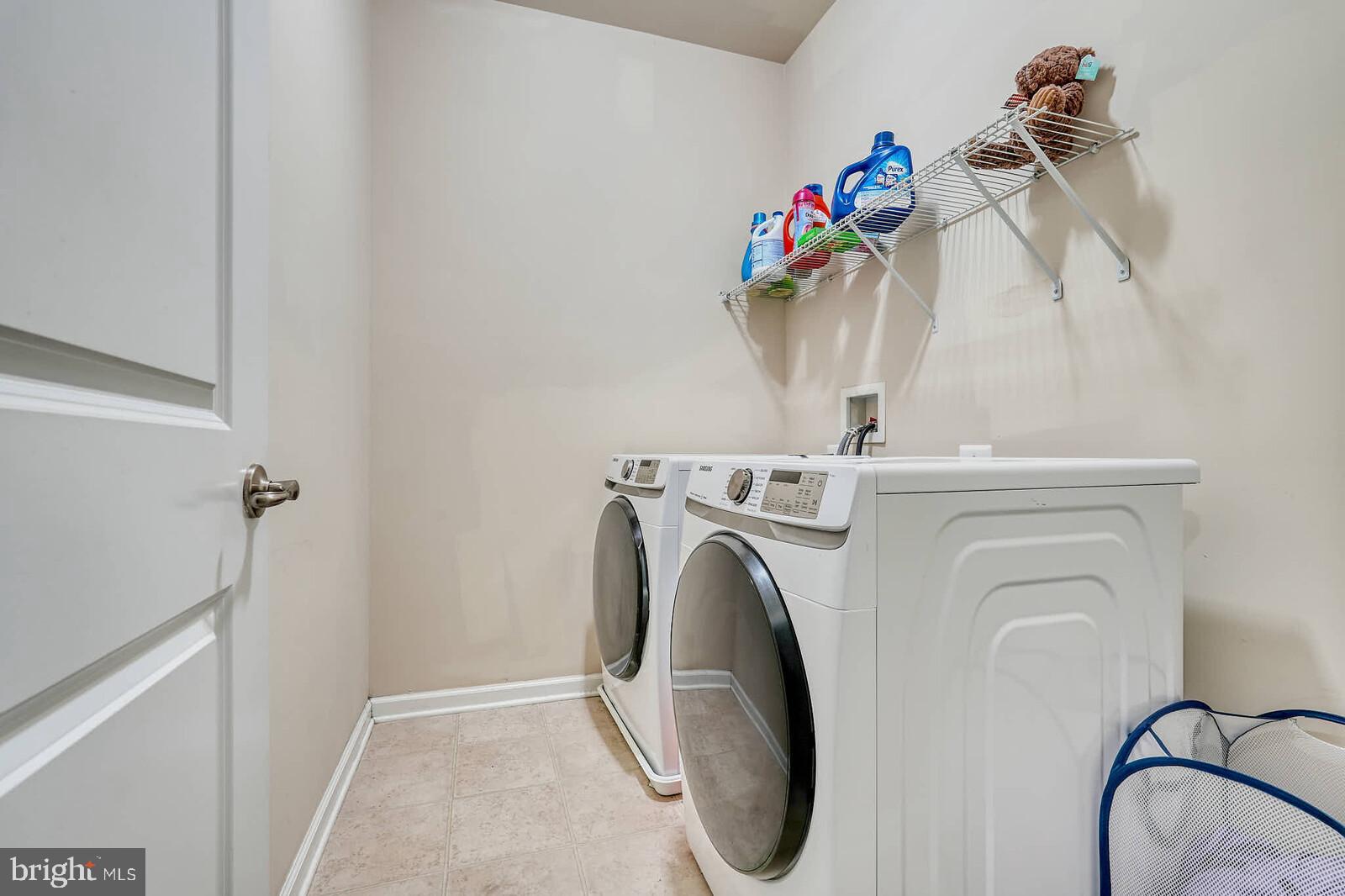 5183 Wyndholme Circle Baltimore, MD 21229 - Photo 27 of 31 a close view of a utility room with dryer and washer