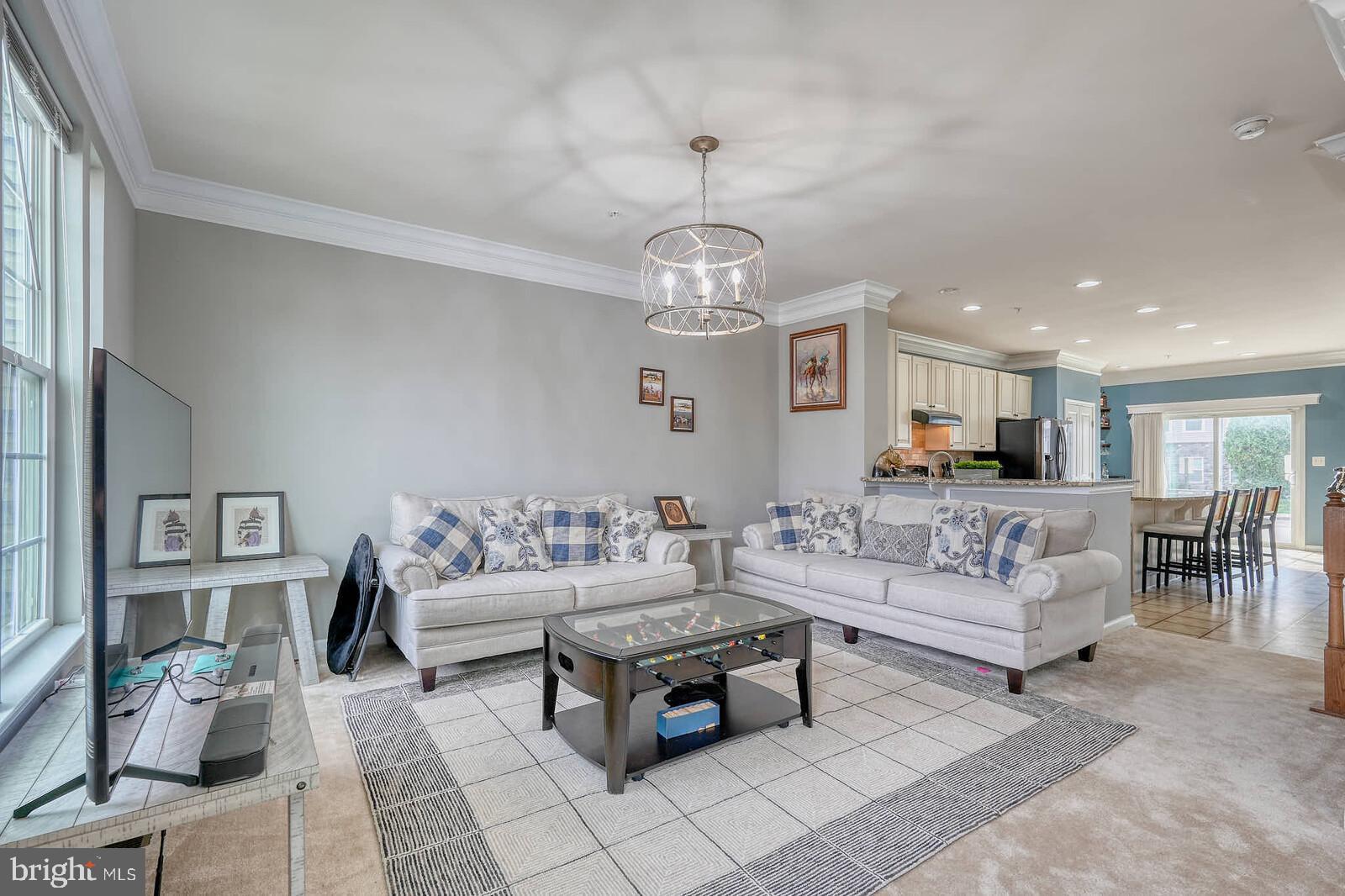 5183 Wyndholme Circle Baltimore, MD 21229 - Photo 3 of 31 a living room with furniture a dining table and a chandelier