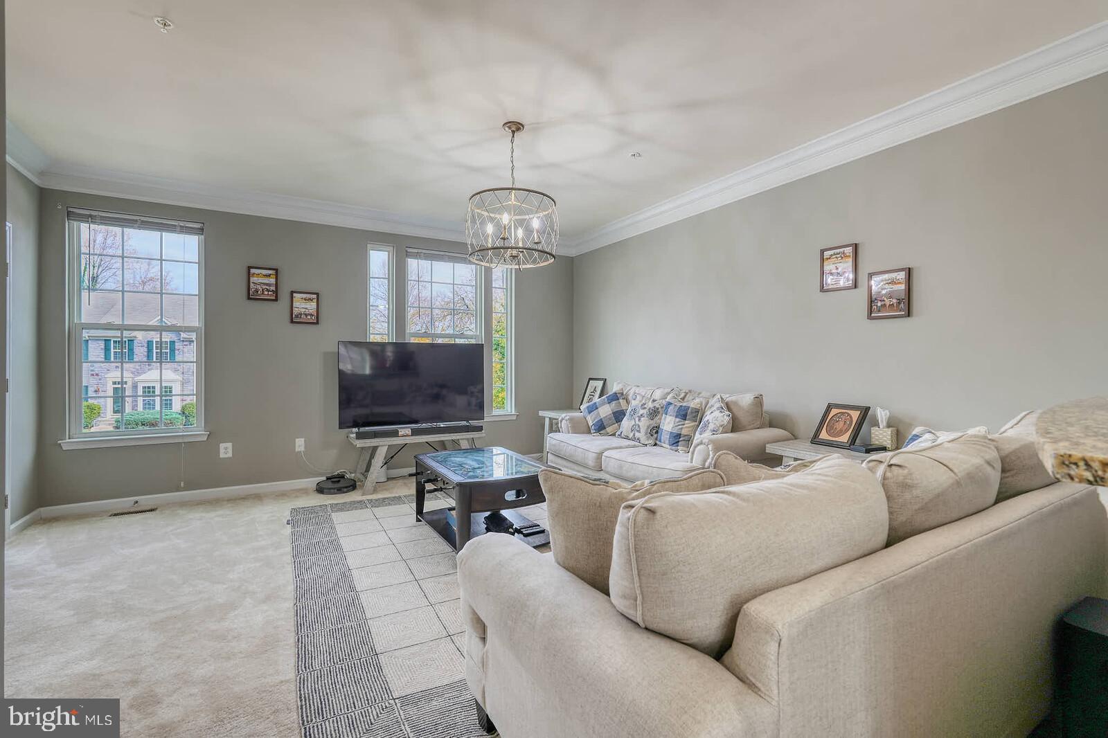 5183 Wyndholme Circle Baltimore, MD 21229 - Photo 4 of 31 a living room with furniture a window and a chandelier