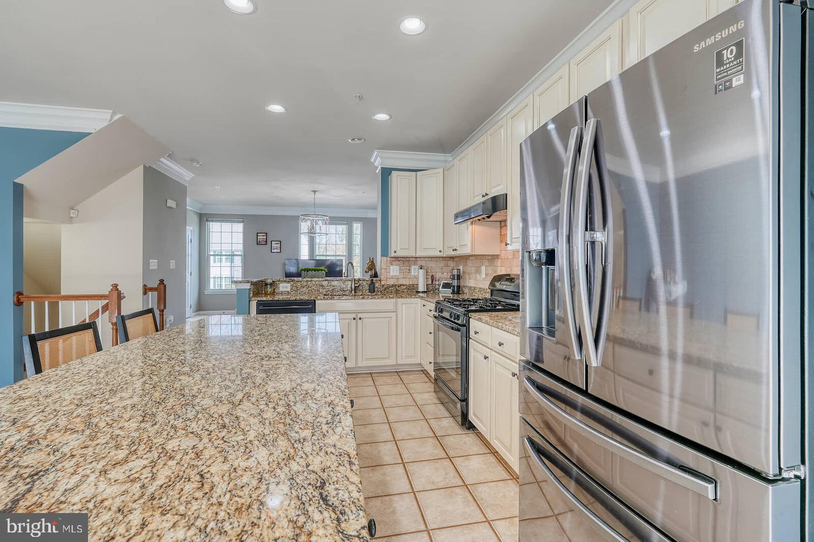5183 Wyndholme Circle Baltimore, MD 21229 - Photo 10 of 31 a kitchen with stainless steel appliances a refrigerator sink and cabinets