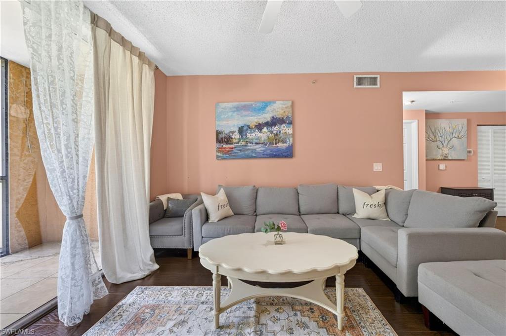 1105 Reserve Court, Unit 206 Naples, FL 34105 - Photo 10 of 23 a living room with furniture and a couch