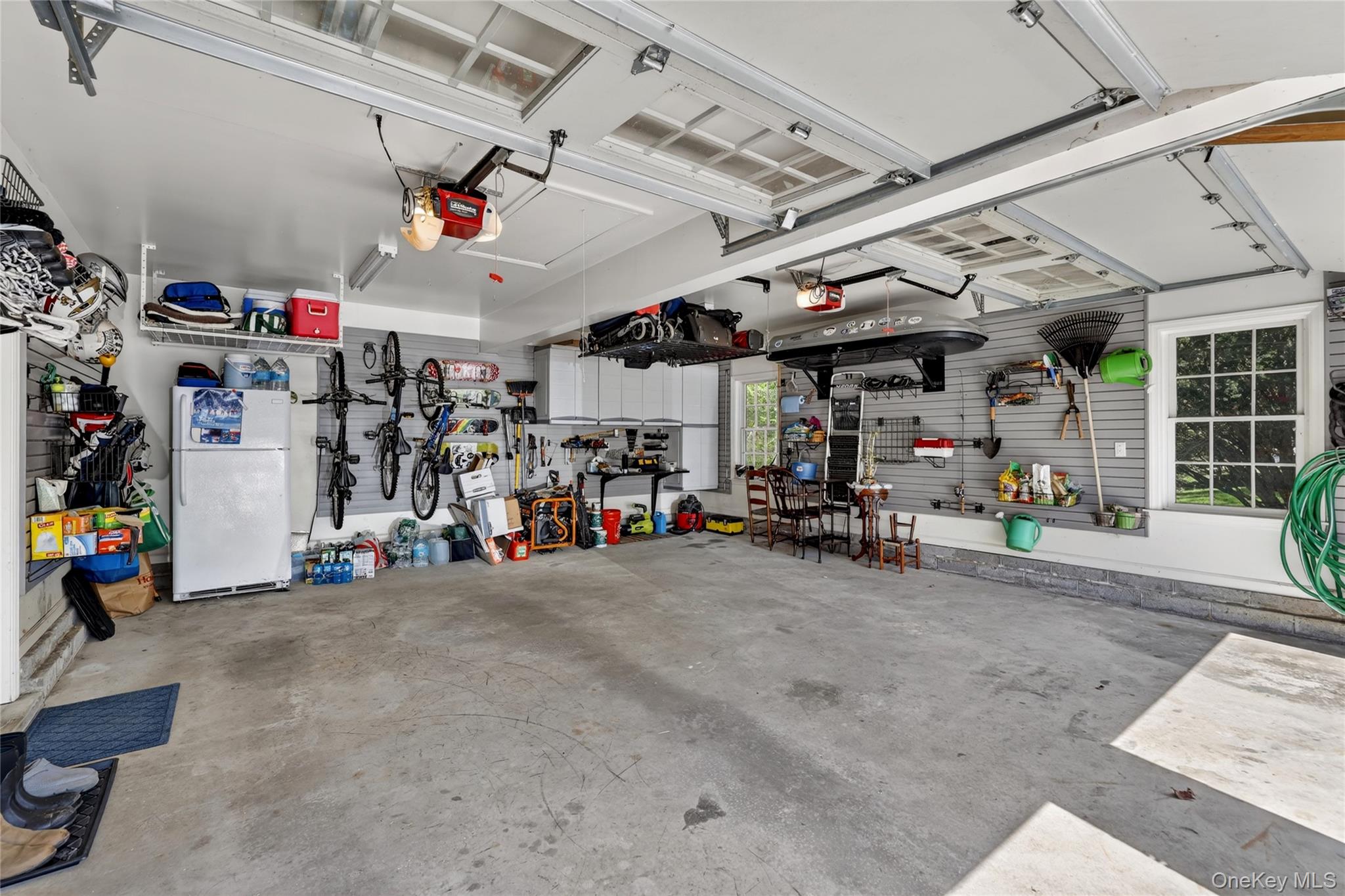 301 Bear Ridge Road Pleasantville, NY 10570 - Photo 32 of 48 Two car garage with shelving and Besler stairs to access storage area.