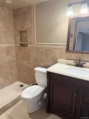 a bathroom with a sink a toilet and mirror