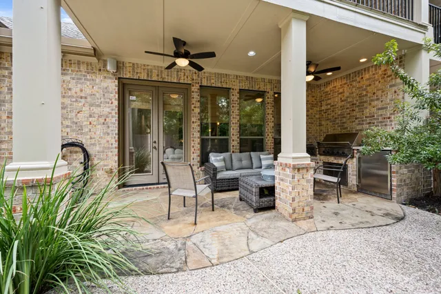 a living room with fireplace furniture and a potted plant