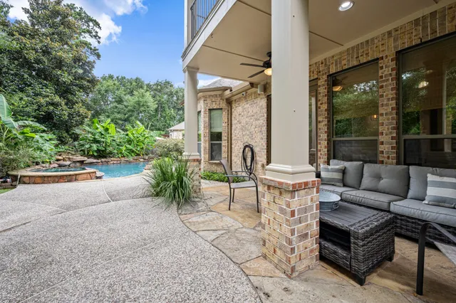 a view of a patio with couches table and chairs and potted plants