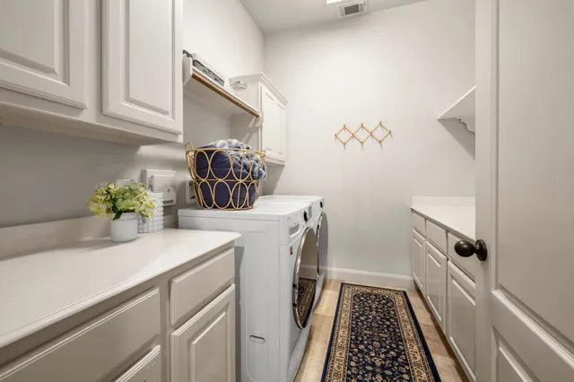 a utility room with sink dryer and washer