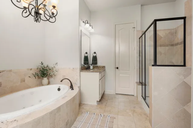 a bathroom with a bathtub and a shower