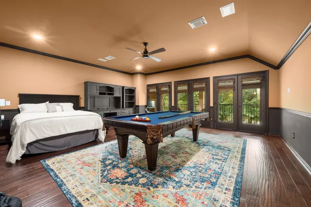 a bedroom with furniture and a large window