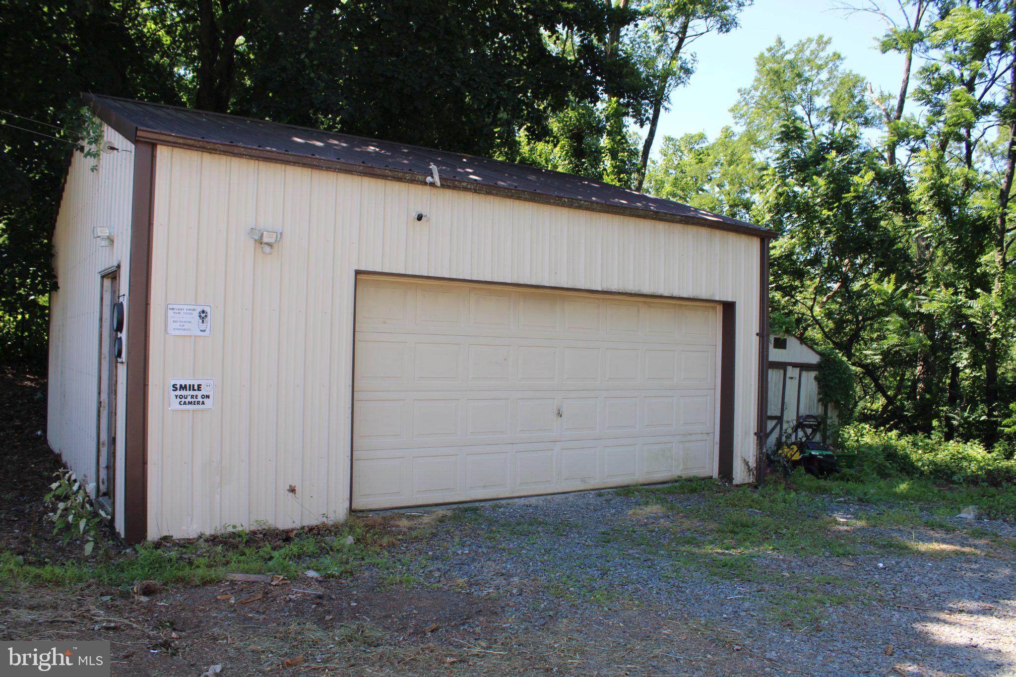 182 Rose Valley Road Pottstown, PA 19464 - Photo 14 of 52 Spacious garage nestled in greenery.