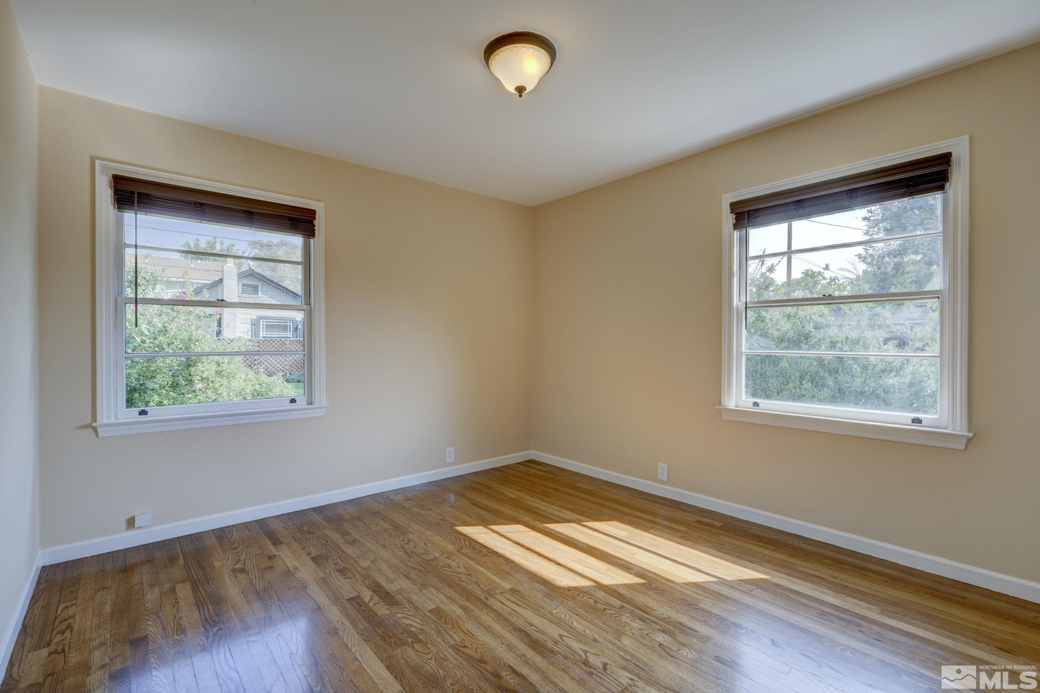619 Thoma Street Reno, NV 89502 - Photo 11 of 40 a view of empty room with window and wooden floor