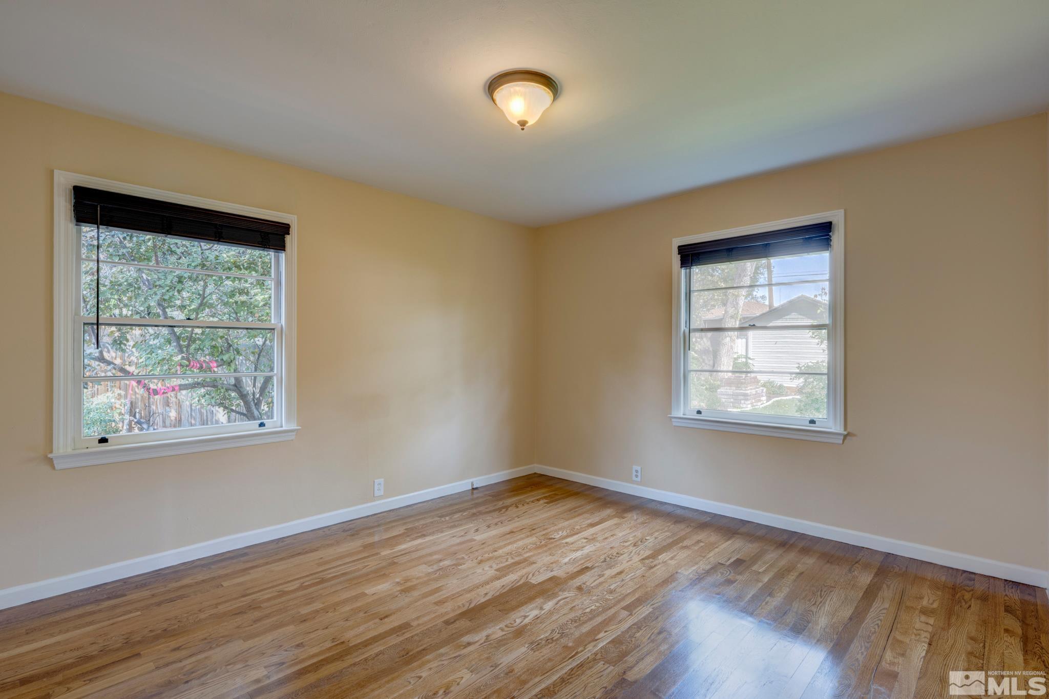 619 Thoma Street Reno, NV 89502 - Photo 15 of 40 a view of an empty room with wooden floor and a window