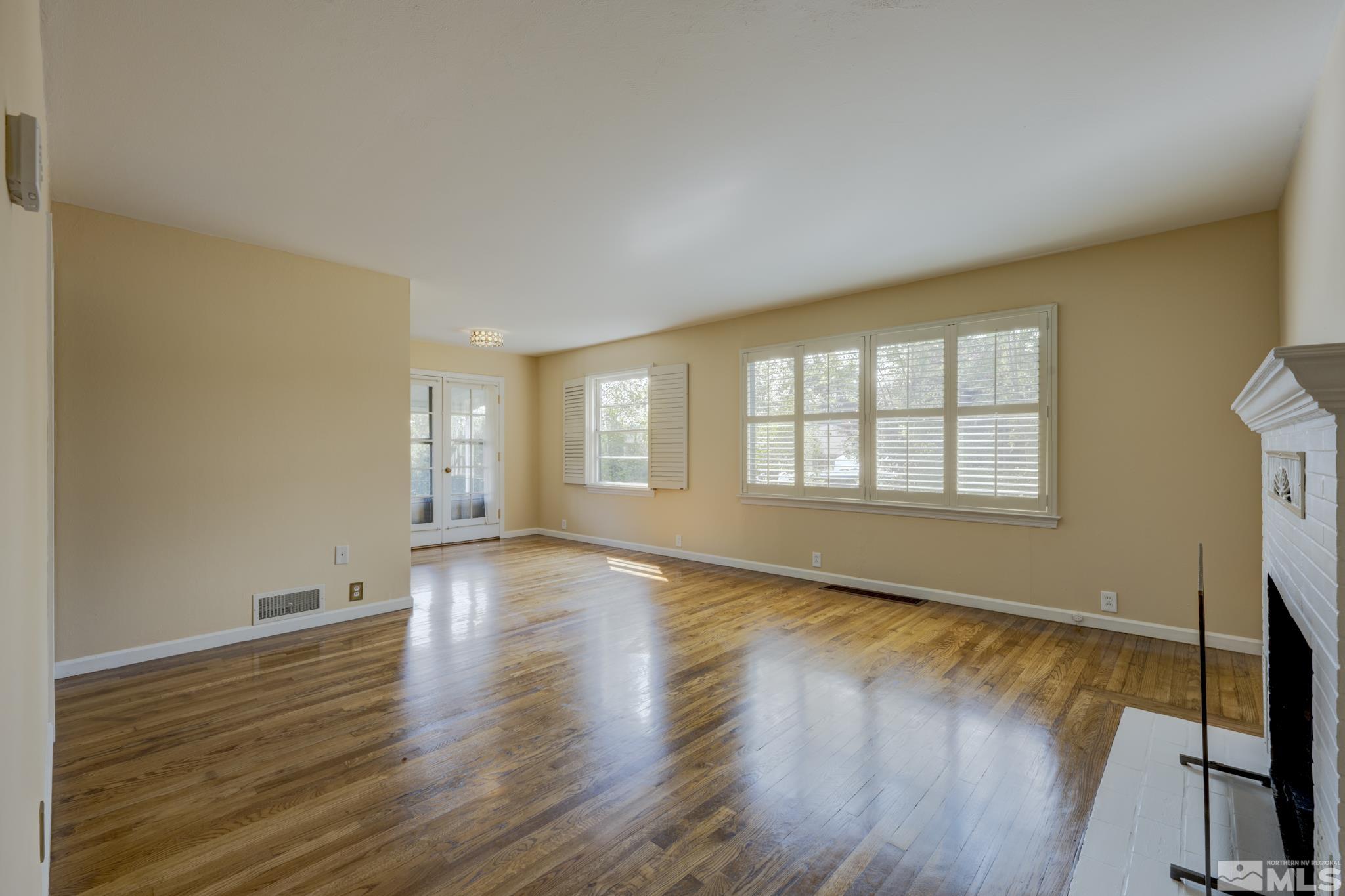 619 Thoma Street Reno, NV 89502 - Photo 5 of 40 a view of an empty room with wooden floor and a window