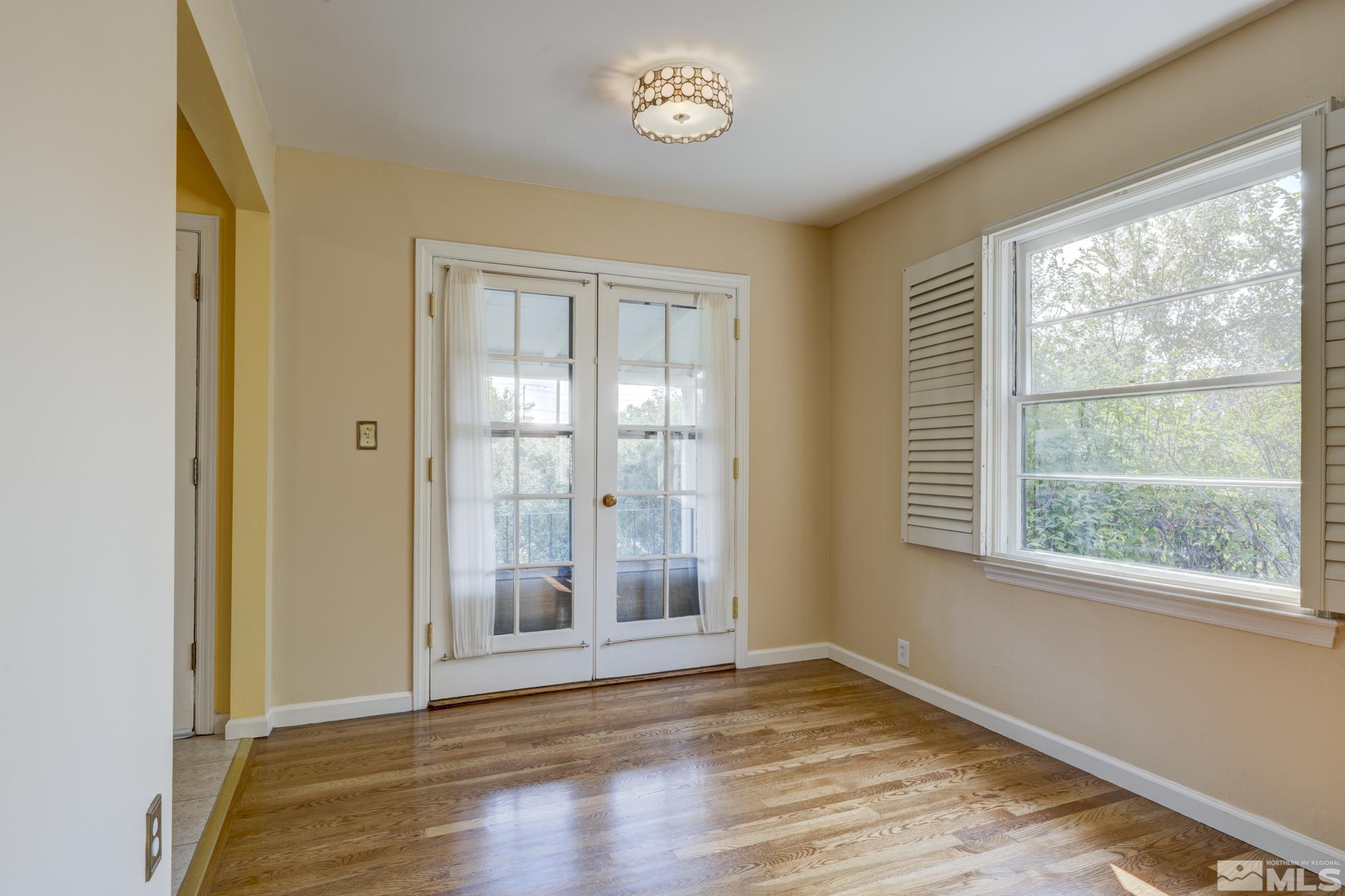 619 Thoma Street Reno, NV 89502 - Photo 7 of 40 a view of an empty room with wooden floor and a window