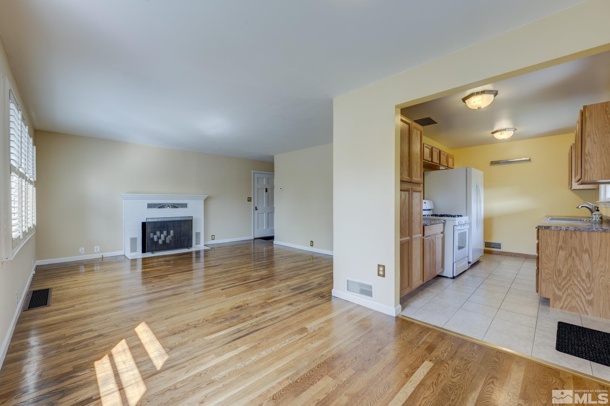 619 Thoma Street Reno, NV 89502 - Photo 8 of 40 a view of empty room with wooden floor and fireplace