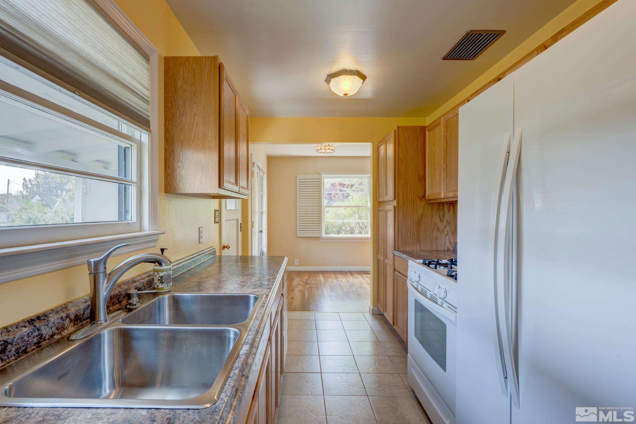 619 Thoma Street Reno, NV 89502 - Photo 10 of 40 a kitchen with a sink and a refrigerator