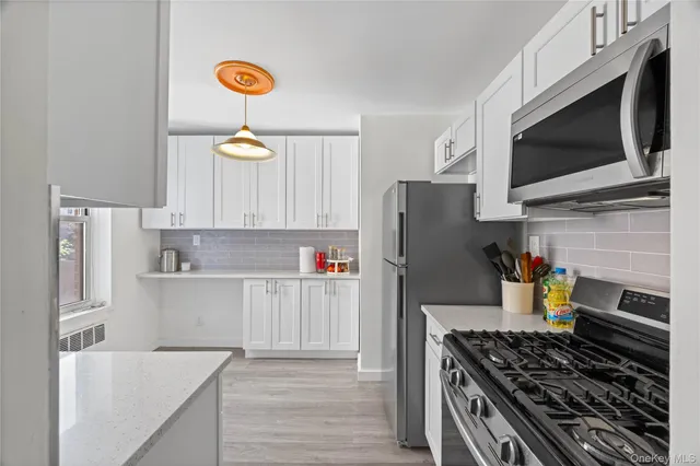 a kitchen with stainless steel appliances granite countertop a refrigerator stove and microwave