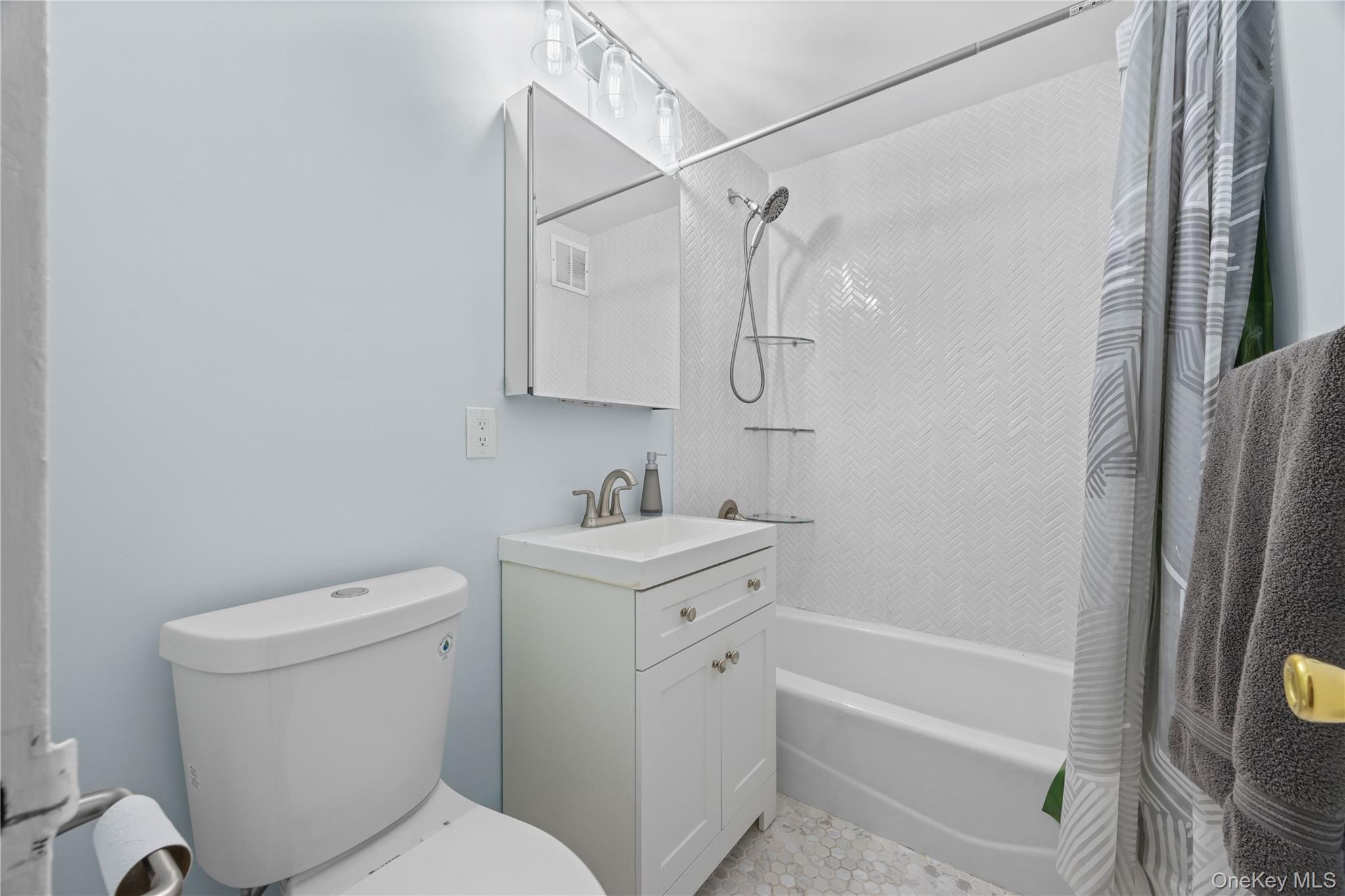 2736 Independence Avenue, Unit 4A Bronx, NY 10463 - Photo 13 of 31 a bathroom with a sink a toilet and shower