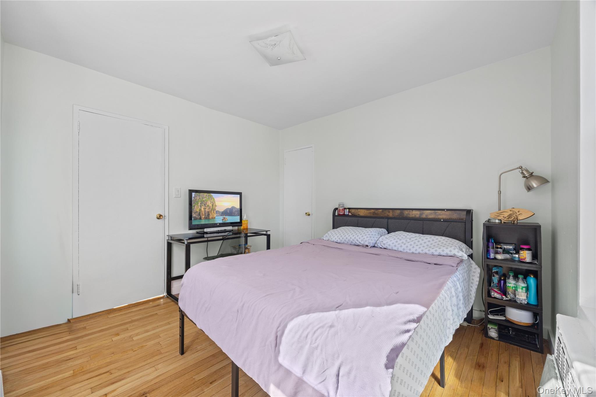 2736 Independence Avenue, Unit 4A Bronx, NY 10463 - Photo 23 of 31 a bedroom with a bed and a book shelf