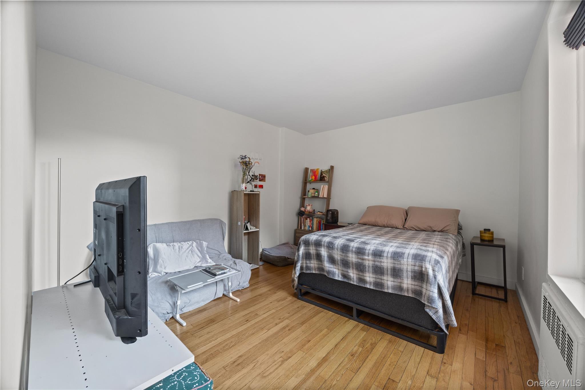 2736 Independence Avenue, Unit 4A Bronx, NY 10463 - Photo 6 of 31 a bedroom with a bed and wooden floor
