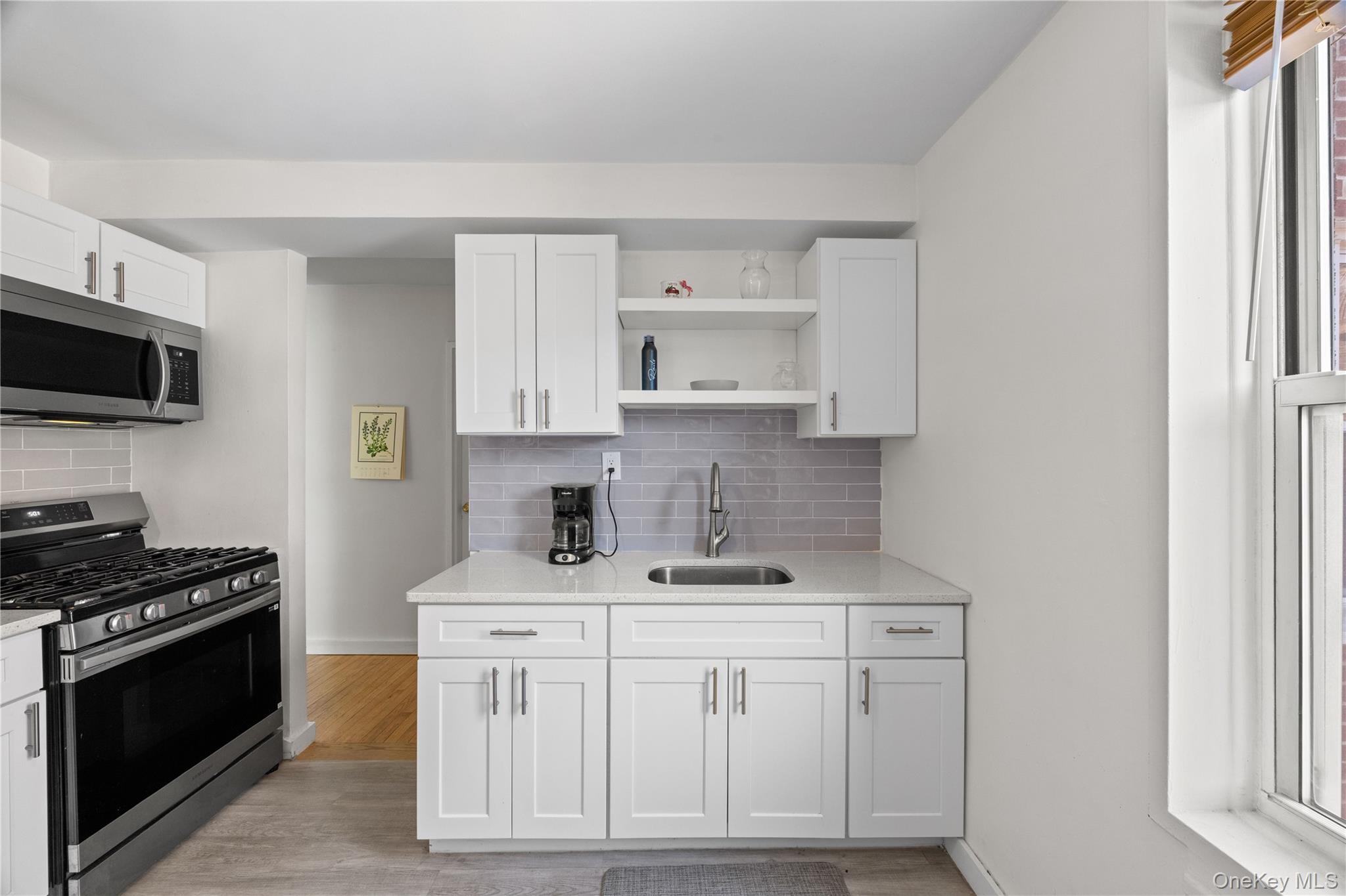 2736 Independence Avenue, Unit 4A Bronx, NY 10463 - Photo 10 of 31 a kitchen with white cabinets and appliances