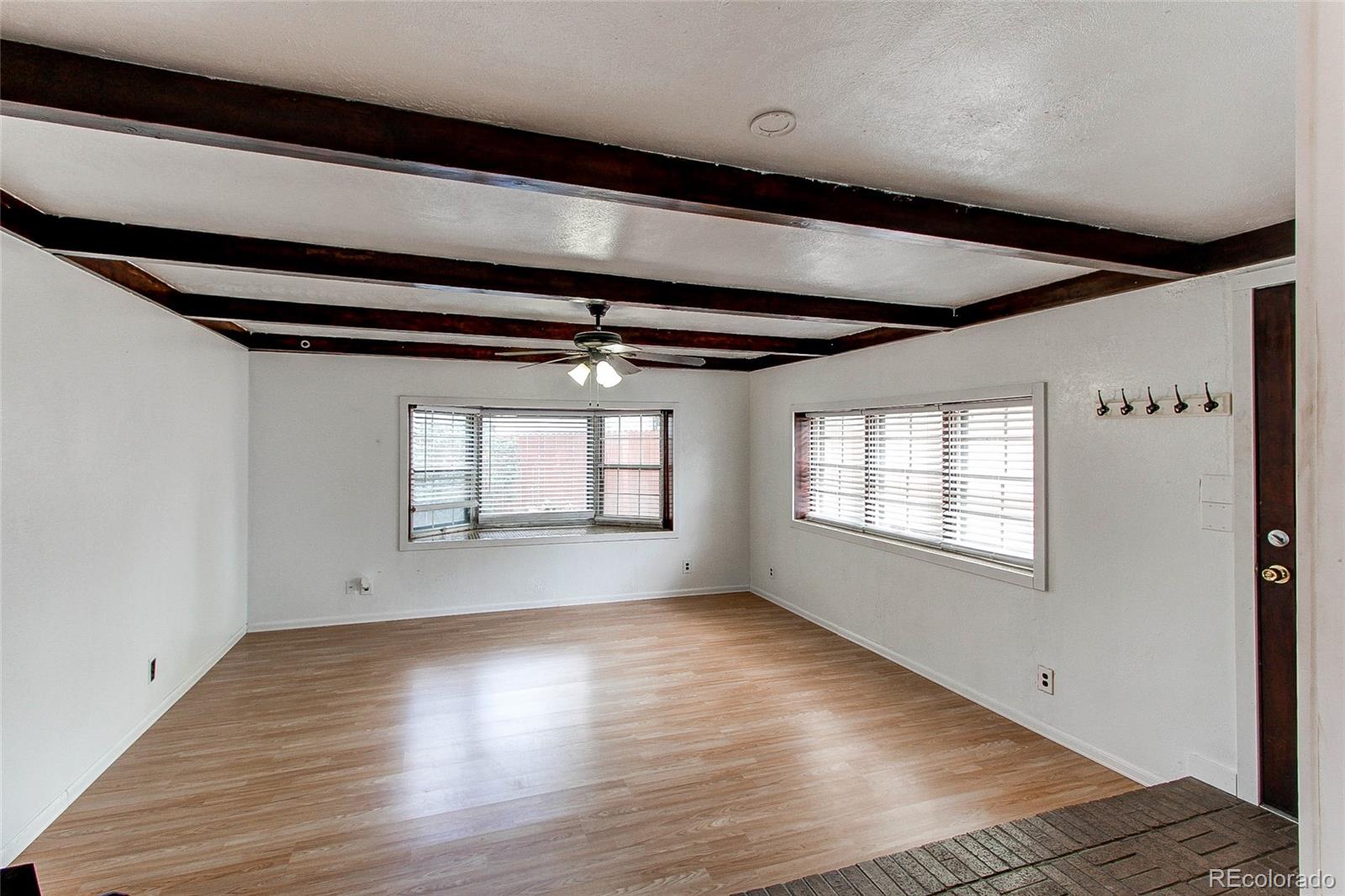 1015 Mac Davidson Circle Dacono, CO 80514 - Photo 11 of 22 a view of empty room with wooden floor and fan