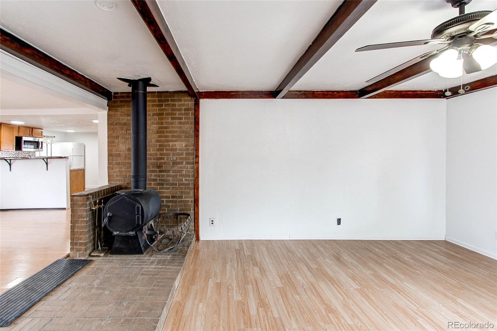 1015 Mac Davidson Circle Dacono, CO 80514 - Photo 12 of 22 a view of livingroom with furniture and refrigerator