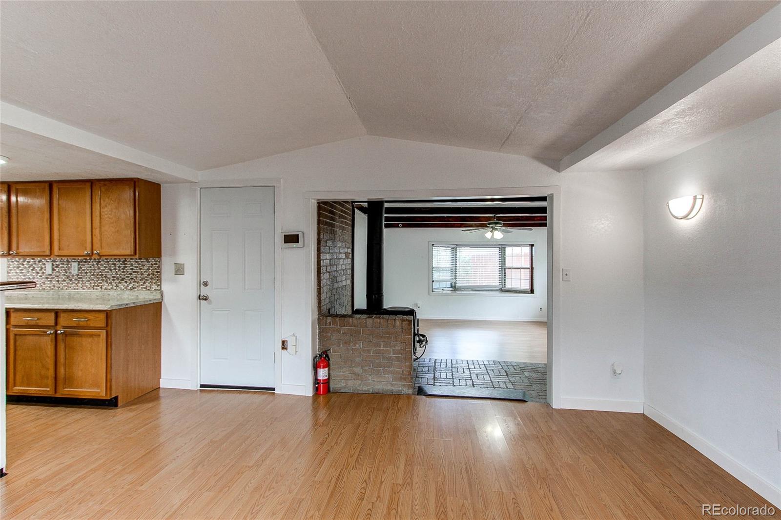 1015 Mac Davidson Circle Dacono, CO 80514 - Photo 9 of 22 a view of a kitchen cabinets a sink and a dishwasher