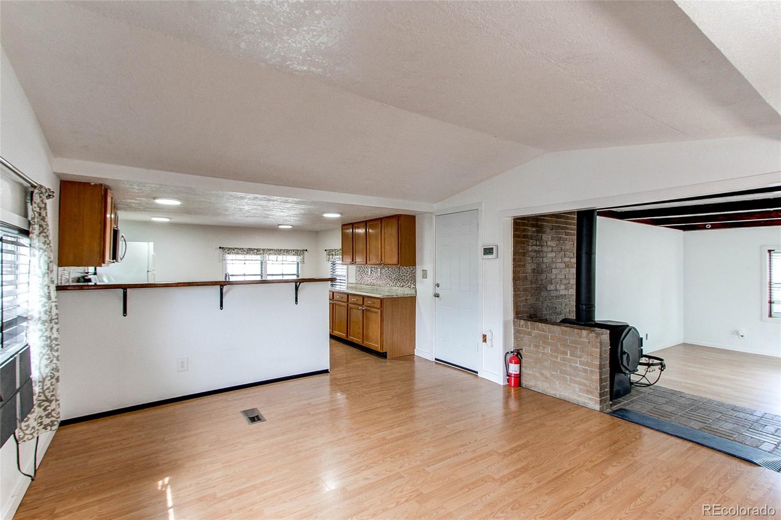 1015 Mac Davidson Circle Dacono, CO 80514 - Photo 10 of 22 a view of kitchen with furniture and wooden floor