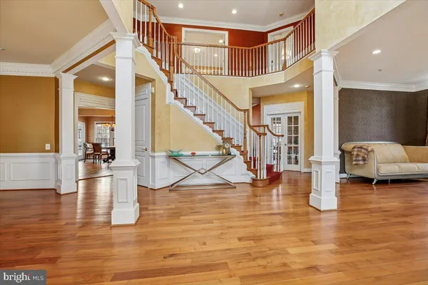a view of entryway and hall with wooden floor
