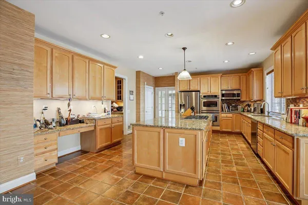 a open kitchen with stainless steel appliances granite countertop a stove top oven a sink dishwasher and cabinets