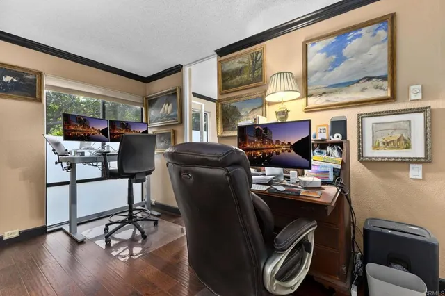 a living room with furniture a floor to ceiling window and a table