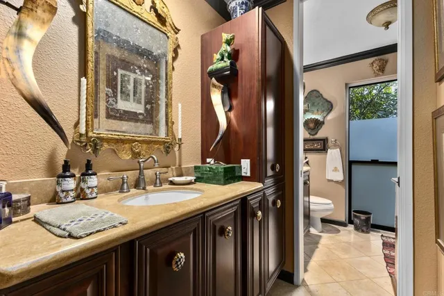 a bathroom with a toilet a sink and a mirror