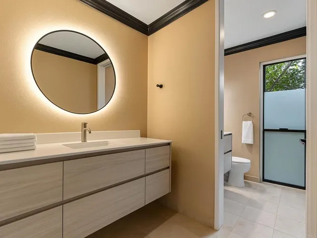 a bathroom with a toilet sink and mirror