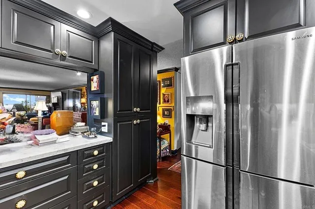 a living room with furniture a large window with kitchen view