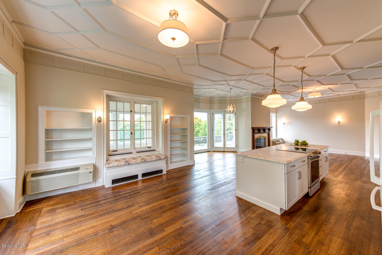 11 Prospect Hill Road, Unit B Stockbridge, MA 01262 - Photo 3 of 13 a kitchen with stainless steel appliances a stove top oven and a chandelier