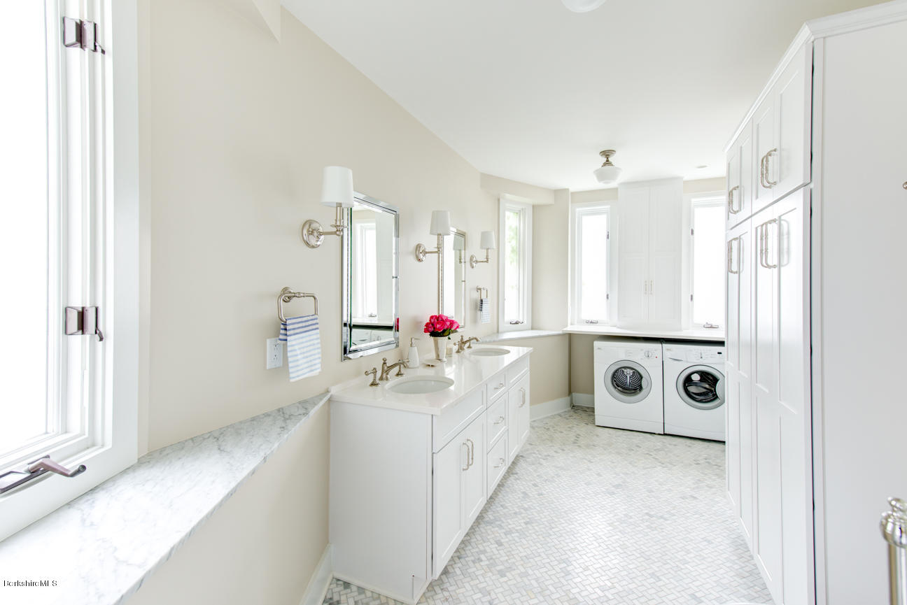11 Prospect Hill Road, Unit B Stockbridge, MA 01262 - Photo 8 of 13 a en suite bathroom with double vanity sinks a mirror and a bathtub