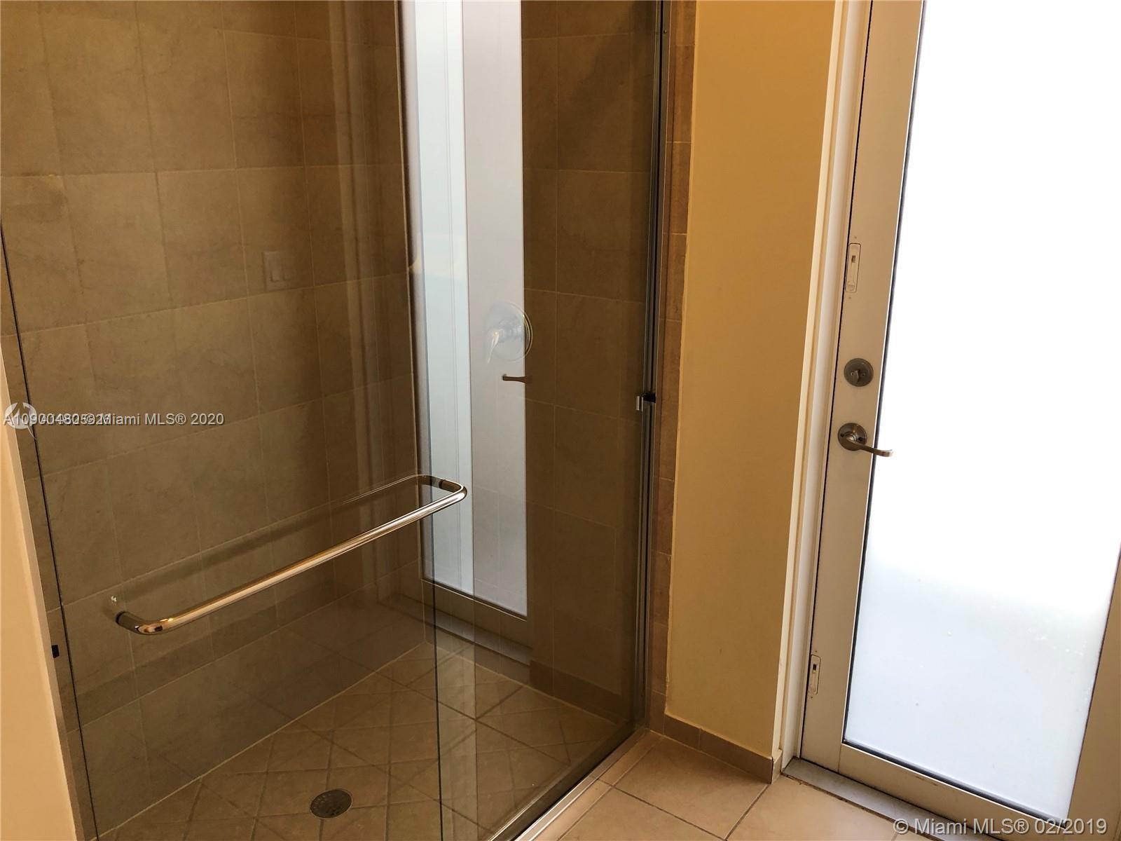 9458 Southwest 170th Path Miami, FL 33196 - Photo 30 of 97 first floor bathroom with shower and door leading to the patio. Can be used as Cabana bath.