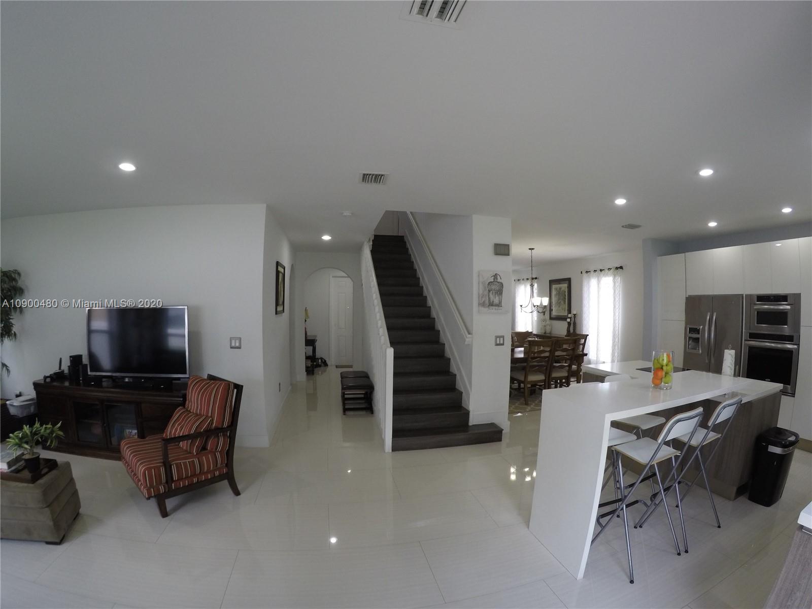 9458 Southwest 170th Path Miami, FL 33196 - Photo 3 of 97 On your left the great family room, at your right the kitchen, further right the formal dining living room.