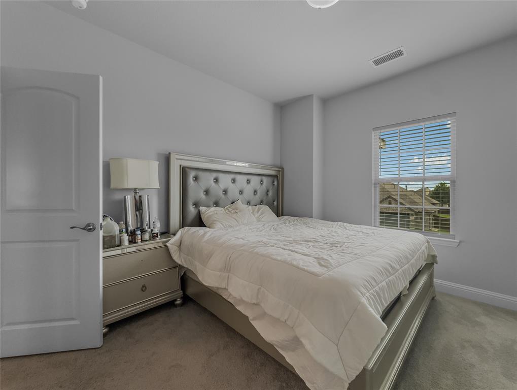 116 Chaco Drive Forney, TX 75126 - Photo 11 of 27 a bedroom with a bed and a window